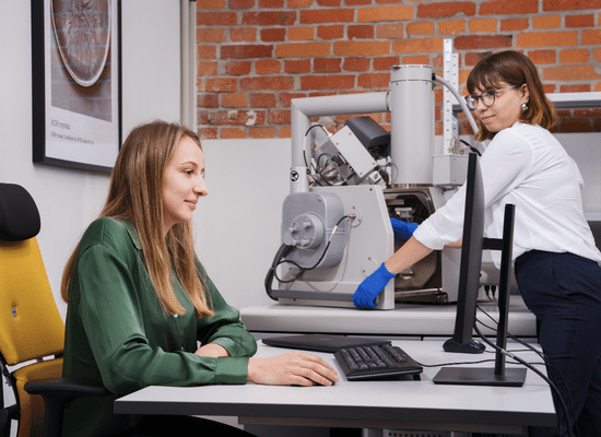 The scientists of Nanores Lab with microscope